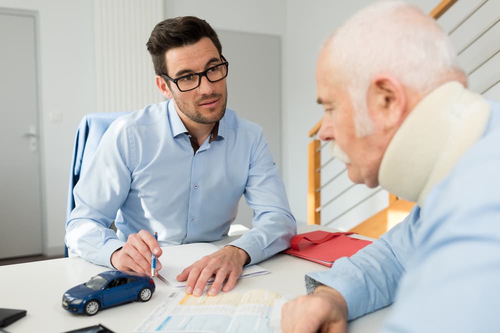 old man consulting a lawyer for his claim process