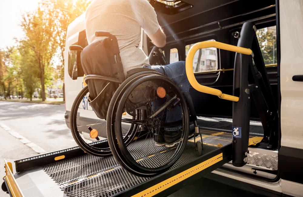 paralyzed man on lift vehicle
